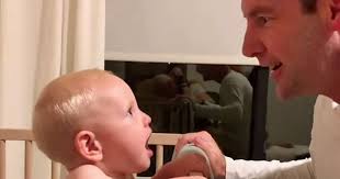 Baby baffled by dad's new look revealed during game of peek a boo