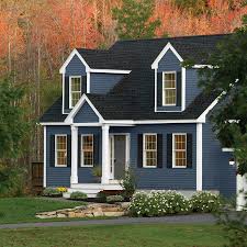Blue verging on gray is a terrific color for this modern northwest style home with splashes of natural wood. Dark Navy Blue House With White Trim Novocom Top