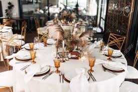 Maybe you would like to learn more about one of these? Wedding Banquet Stylish Table Design In Brown And Yellow Compositions Of Dried Flowers And Fluffy Spikelets In The Center Of The Round Table Stock Photo Picture And Royalty Free Image Image 141660677