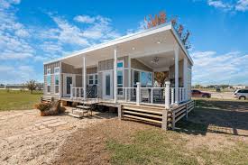 A wrap around porch and the surrounding landscape and protection from the weather. Oversized Tiny House With Wraparound Porch