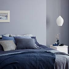 A grouping of small blue and white vases are hung over the bed and the lamps are made from glazed terra cotta fragments off a building. Blue Bedroom Ideas See How Shades From Teal To Navy Can Create A Restful Retreat In Any Home