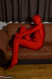 Brunette female unzips her full bodysuit to show her bald pussy in the nude  - Pichunter