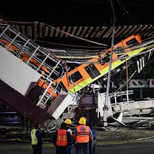 Drone footage shows crews working to stabilize a collapsed bridge in mexico city while train carriages continue to hang from the overpass. Toman2ygjwnofm