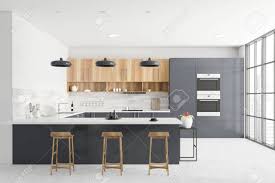 Milano ultra kitchen in dove. Interior Of Modern Kitchen With Grey And White Walls Grey Countertops Wooden Cupboards Bar With Stools Two Ovens And Window With Blurry Cityscape 3d Rendering Banque D Images Et Photos Libres De Droits
