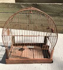 I have 1 artificial bird on it's perch and i put artificial ivy at the bottom and intertwined it between the wires. Diy Vintage Bird Cage Planter