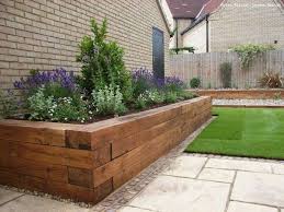 Love these plantar boxes with metal and wood. 17 Fascinating Wooden Garden Edging Ideas You Must See The Art In Life Wooden Garden Edging Backyard Landscaping Front Yard Landscaping