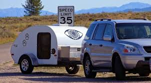 Three bumper stickers on the back of a recreational vehicle talk about geico, and the one shaped like a moose is shocked to learn that he's not a real moose. Is A Travel Trailer Covered By My Auto Insurance Glamping Or Camping All Your Questions Answered
