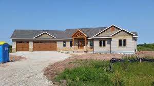 Once you dive in with your siding choice, the next step is selecting accent and trim colors. New Home Featuring Certainteed Monogram Natural Clay Siding With Hearthstone Shakes In The Gables Certainte Architectural Shingles House Exterior Brick Siding