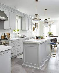 Light Grey Kitchen With Celestial Chandelier Over The Kitchen Table White Quartz Countertops White Kitchen Design Grey Kitchen Designs Kitchen Cabinet Design