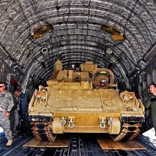 A Soldier Backs An M32 Bradley Fighting Vehicle Into A C 17 Cargo Bay For Transport Back To Us Army Fort Be Bradley Fighting Vehicle Military Military Pictures