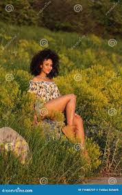 Beautiful African Girl with Curly Hair in a Field of Yellow Flowers Stock  Image - Image of black, european: 71608737