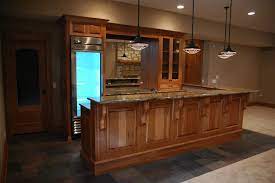 This kitchen was designed with natural knotty hickory cabinets, red indian ceramic tile, and lime stone counter tops. Rustic Kitchen Cabinets Cabinets With Grey Tiles Like Stones In Inspiring Rustic Kitche Rustic Farmhouse Kitchen Hickory Cabinets Rustic Kitchen Cabinets