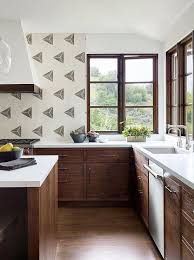 While dark cabinets will pop out beautifully against a light colored wall, they also look great when matched with dark flooring or other dark colored elements in the kitchen. Brown Oak Cabinets With White Quartz Countertops Transitional Kitchen