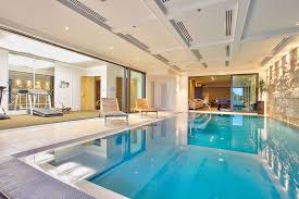 Obviously, the expense of upkeep is a big disincentive for potential buyers. Cliff Top Panorama In Auckland Luxury Pools Indoor Swimming Pool Design Indoor Swimming Pools