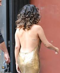The black and white image depicts praying selena gomez debuts huge upper thigh tattoo of hands praying with a rosary after her comeback performance at american music awards. Selena Gomez Glitters In Slinky Gold Dress On Set Of Next Music Video Daily Mail Online