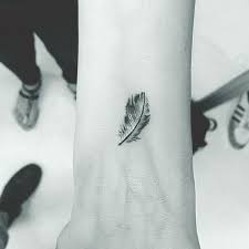 20 Catchy Small Tattoo Designs With Strong Meaning Small Feather Tattoo Feather Tattoos Feather Tattoo Wrist