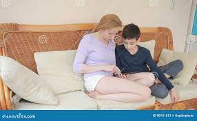 Mom and Her Son Teenager Speak Well, Look at the Tablet Touch the Touch  Screen Stock Video - Video of adult, parent: 90131813