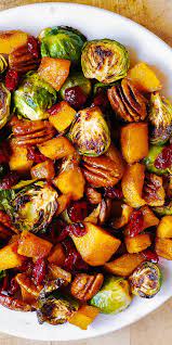 Thanksgiving Butternut Squash And Brussels Sprouts With Pecans And Cranberries Vegan Thanksgiving Recipes Veggie Dishes Sprout Recipes
