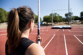 Enjoy the magical world and magnificent sights of this 2019 indoor athletics female pole vaulting team of italy. Female Pole Vaulter Preparing Stockphoto