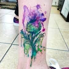 This black tribal thistle design sits on top of a celtic knot. What Does Thistle Tattoo Mean Represent Symbolism