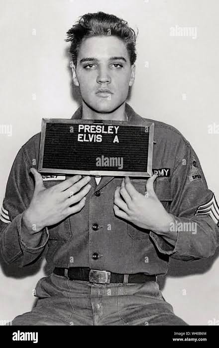 ELVIS PRESLEY (1935-1977) American singer and film actor in his official  army records photo from March 1958 Stock Photo - Alamy
