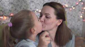 Christmas Kiss Between Mother And Child.
