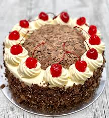 Detail on a slice of a black forest cake, or traditional austria schwarzwald cake from dark chocolate and sour cherries. The Best Black Forest Cake King Of Cakes Brisbane