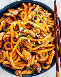 Overhead Shot Of Hoisin Chicken Udon Noodles In A Blue Bowl Garnished With Green Onions And A Pair Of Hoisin Chicken Chicken Udon Noodles Asian Noodle Recipes