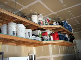 And it also can be raised and lowered, so accessing it is a snap. Overhead Garage Shelving Diy Overhead Garage Storage Garage Storage Shelves Garage Shelving Plans