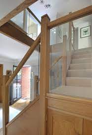 A Centrally Positioned Oak And Glass Staircase With A Half Landing Turn And Gallery Landing Staircase Design Glass Staircase Stairs Design