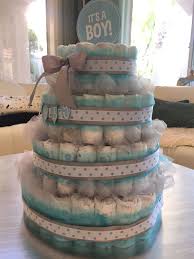 Following are some tutorials that will be helpful when assembling your first diaper cake. Diaper Cake Made With Aqua And Gray Tulle Silver Ribbon And Polka Dot Ribbon 4 Tiers About 120 Diapers Diaper Cake Baby Diaper Cake How To Make Cake