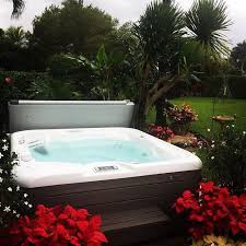 This Backyard Paradise Is Perfect For A Hot Tub Flowers Trees And Plenty Of Sunshine Hot Tub Landscaping Hot Tub Outdoor Hot Tub