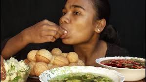 EATING PANI PURI WITH SPICY WATER