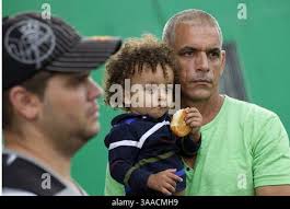 Cuban migrants Angel Reyna Rojas, Shairas Zakir Pino Espinosa, 1 and a half  years old, and Rafael Pino Espinosa wait to be processed outside the  Mexican National Institute of Migration shortly after