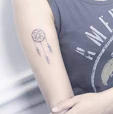 Just like in real dream catchers, dream catcher tattoos for women also intend to invoke protection and good dreams. Small Dreamcatcher Tattoo On The Right Bicep