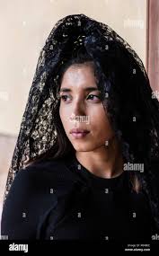 A 20 year old MEXICAN WOMAN dressed in a traditional MANTILLA worn during  Easter at JARAL DE BERRIOS, a historical hacienda