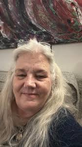 What hairstyle would suit a 60-year-old woman with natural silver hair?