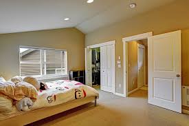 In her airy california cottage, the master bedroom is awash in a variety of white hues, from white painted planked walls to a white slipcovered chair to layers of soft and pretty white bedding. Modern Bedroom Door Designs For Your Home Design Cafe