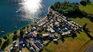Immersed in the green and directly by the sea, camping paradiso is a natural garden of 30.000 sqm, completely shaded by palm trees, eucalyptus and pine. Tessin Camping Paradiso Lago Melano
