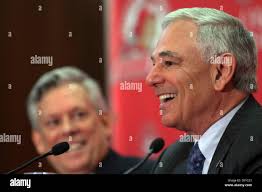 New York Mets senior vice president of baseball operations, Jim Duquette,  left, and catcher Mike Piazza, right, talk after Piazza finished catching  for pitcher Pedro Martinez, during live batting practice, Tuesday, Feb.