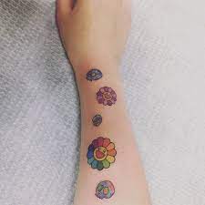 Murakami is well known for his colorful smiling flowers, which the colorful 6ix9ine added to his ongoing collection on october 20th. Murakami Tattoo Kpop Tattoos Small Colorful Tattoos Bts Tattoos