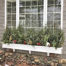 Winter window boxes don't necessarily have to feature on window sills. Winter Window Box Ideas