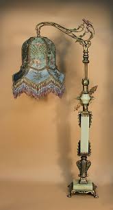 A Table Top Bridge Lamp Is Made From Ornate Metal Parts With A Bird In The Bridge Arm And Three Pieces O Victorian Lamps Small Lamp Shades Rustic Lamp Shades
