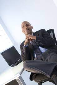 Happy Black Businessman Portrait Of Smiling Black Businessman Reclining In Chai Ad Businessman Portrait Ha Happy Black Business Man Stock Images Free