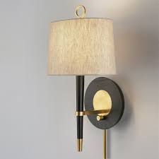 Traditional brass wall sconces add charming warmth that appeals to any home. Jonathan Adler Ventana Sconce Antique Brass Clayton Gray Home