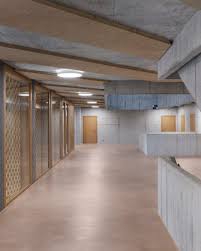 A Set Of Skylights In A Sawtooth Roof Bring Light Down Through The School S Three Storeys And Two Emergency St Romanshorn Secondary School Architecture Details