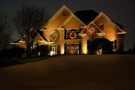 This Well Lit Home Stuns At The Holidays Large Lit Wreaths With Bright Red Bows Hang Outdoor Christmas Garland Outdoor Christmas Lights Best Christmas Lights