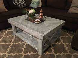I'm fixing up the little studio we have above our garage for its multipurpose use and in my quest of inexpensive furniture of i decided to add a wood top to the surface which i then stained a weathered gray for rustic meets coastal look. Custom Rustic Farmhouse Coffee Table Weathered Grey Stain With White Drybrush And Distressing Coffee Table Farmhouse Coffee Table Weathered Grey Stain