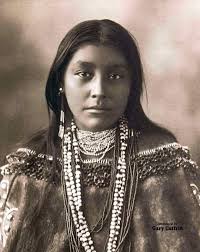 What tribe does this Apache woman's clothing represent?