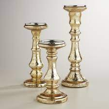 Shiny splattered metallic mercury glass finish coupled with baroque construction make this tantalizing trio a stunning piece of art. Silver Mercury Glass Votive Candleholders Set Of 3 Gold Mercury Glass Wedding Mercury Glass Pillar Candle Holders Gold Mercury Glass